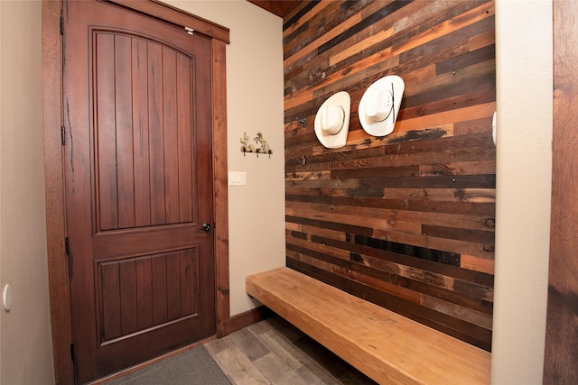 interior space with wood-type flooring and wood walls