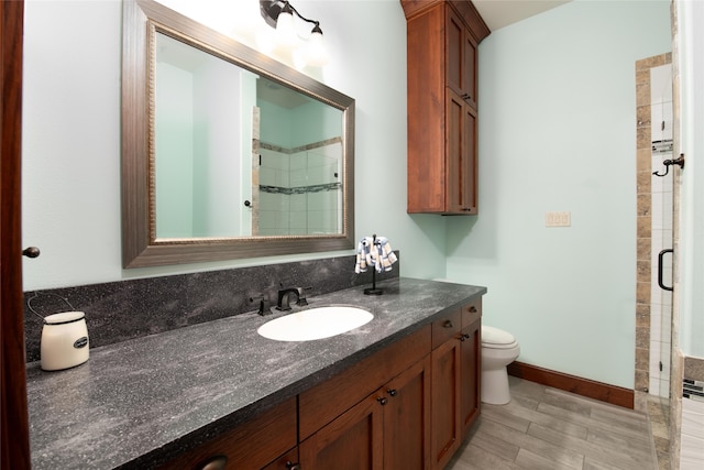 bathroom with oversized vanity, toilet, and walk in shower