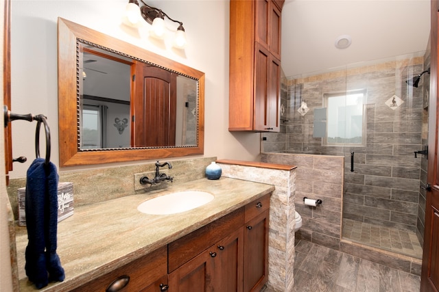 bathroom featuring walk in shower, vanity, and toilet