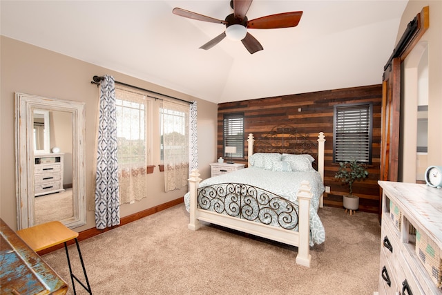 carpeted bedroom with ceiling fan and vaulted ceiling