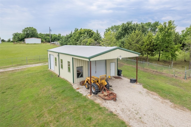 view of outdoor structure with a garage and a lawn