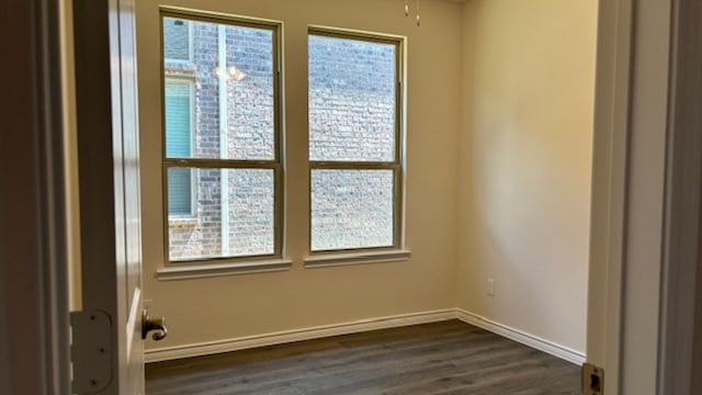 unfurnished room with dark hardwood / wood-style floors