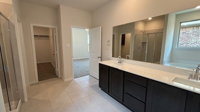 bathroom featuring vanity, tile patterned floors, and plus walk in shower