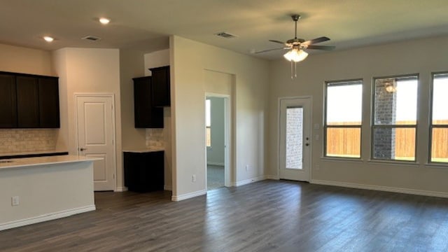 unfurnished living room with dark wood-type flooring and ceiling fan