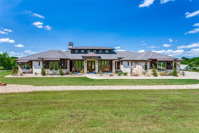 prairie-style home featuring a front lawn