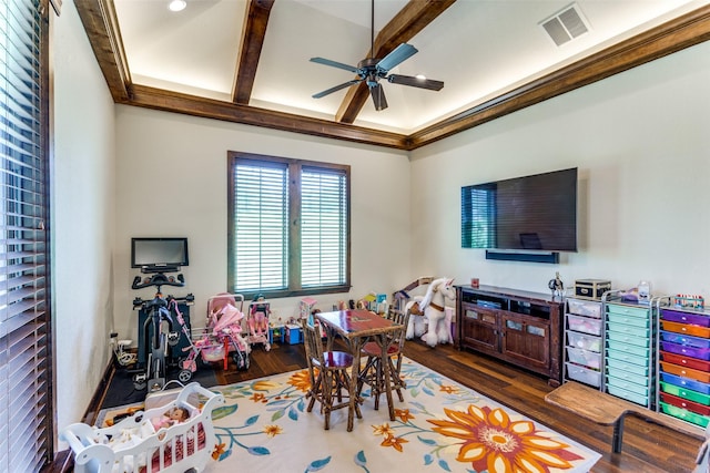 rec room with ceiling fan, beamed ceiling, and dark hardwood / wood-style floors