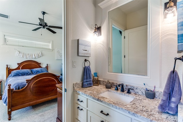 bathroom with ceiling fan and vanity