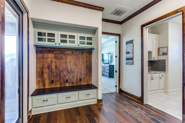 mudroom with crown molding and dark wood-type flooring