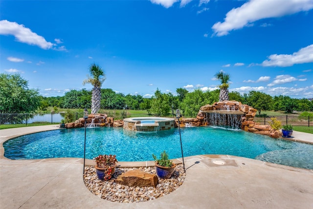 view of swimming pool featuring pool water feature, a water view, an in ground hot tub, and a patio