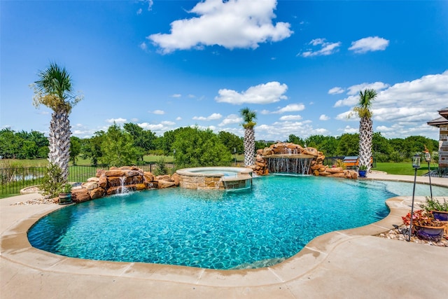 view of pool with pool water feature and an in ground hot tub