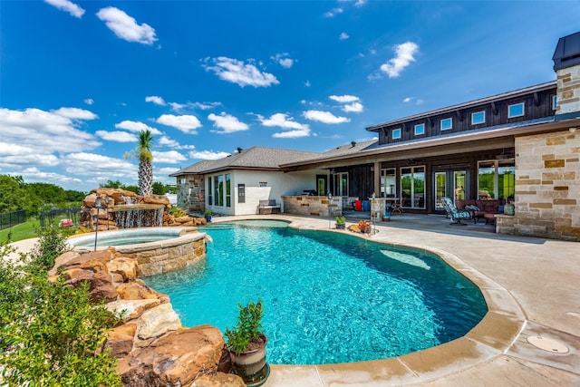 view of swimming pool featuring an in ground hot tub, area for grilling, and a patio area