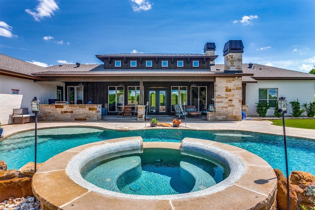 view of pool featuring a patio area and an in ground hot tub