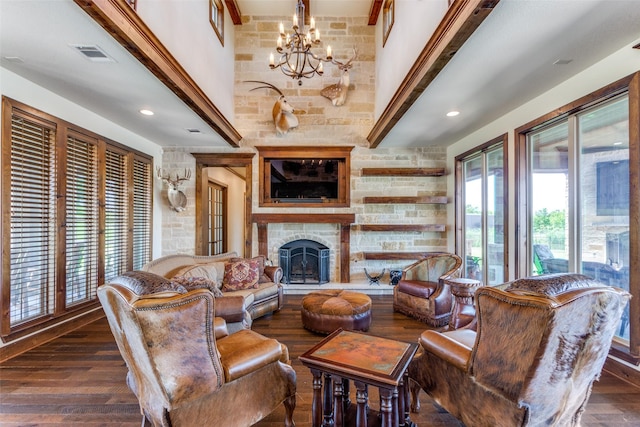 living room with dark hardwood / wood-style floors, plenty of natural light, and a notable chandelier