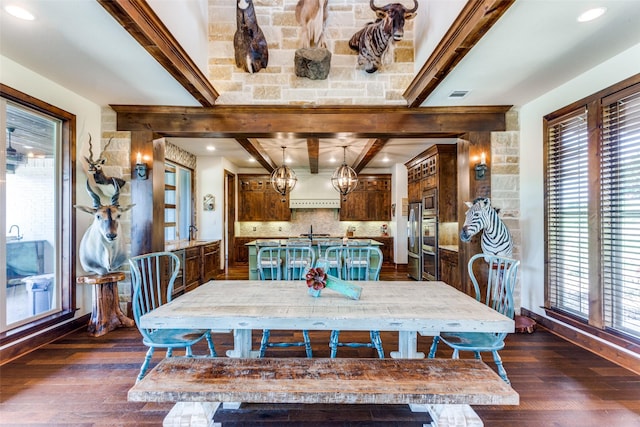 dining room featuring beam ceiling, dark hardwood / wood-style flooring, and a notable chandelier