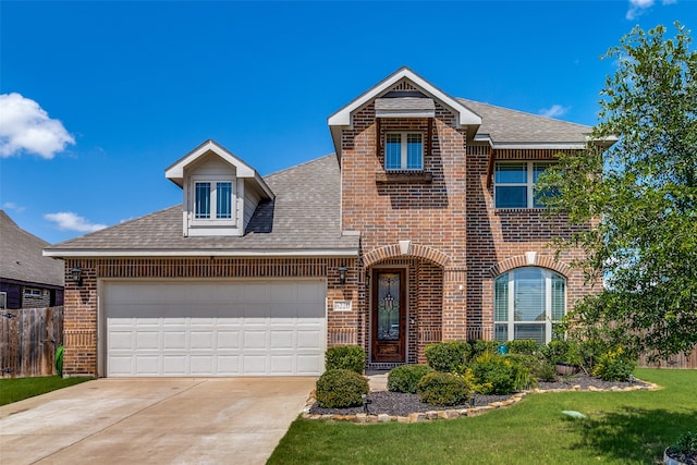 view of front of property with a garage and a front lawn