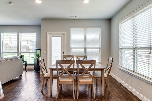 dining space with dark hardwood / wood-style floors