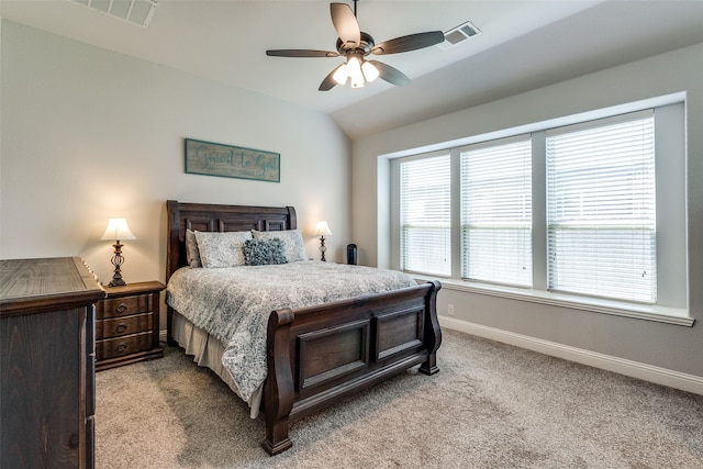 bedroom featuring light colored carpet, multiple windows, lofted ceiling, and ceiling fan