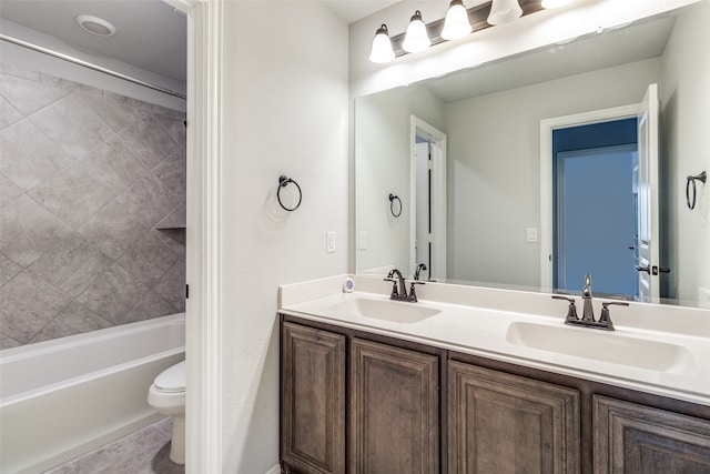 full bathroom with vanity, tiled shower / bath combo, and toilet