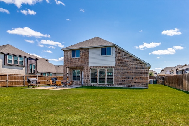 rear view of house with a lawn and a patio area