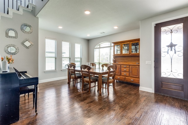 dining space with dark hardwood / wood-style floors