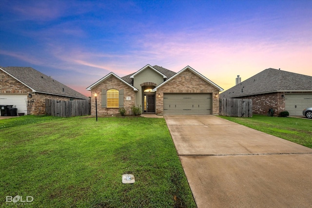 single story home featuring a garage and a yard