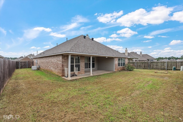 back of house featuring a yard and a patio