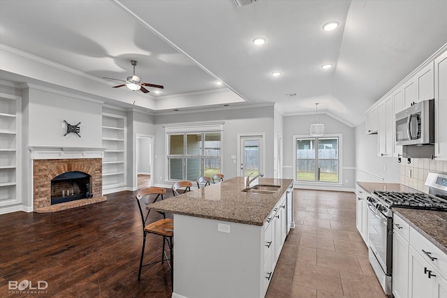 kitchen with white cabinetry, stainless steel appliances, and a breakfast bar area