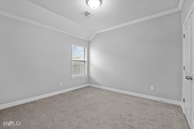 carpeted spare room with crown molding and vaulted ceiling