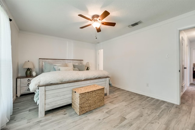 bedroom with crown molding, ceiling fan, and light wood-type flooring