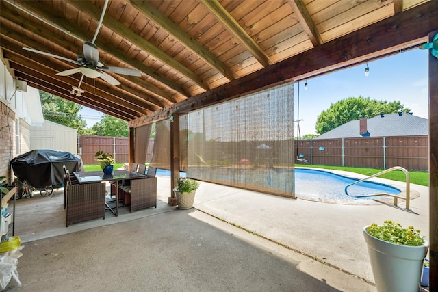 view of patio / terrace with a fenced in pool, area for grilling, and ceiling fan