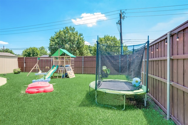 view of yard with a playground and a trampoline