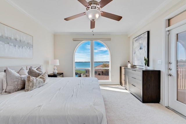 bedroom featuring a water view, ceiling fan, crown molding, and light colored carpet