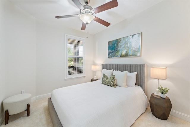 bedroom featuring ceiling fan and light carpet