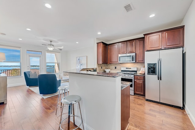 dining space with hardwood / wood-style floors and ornamental molding