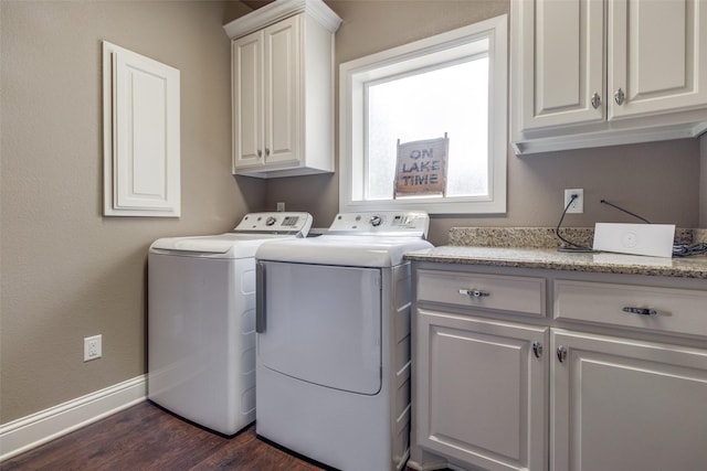 laundry room featuring cabinets, separate washer and dryer, and dark hardwood / wood-style floors