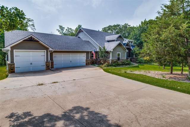 view of front of property with a front lawn and a garage