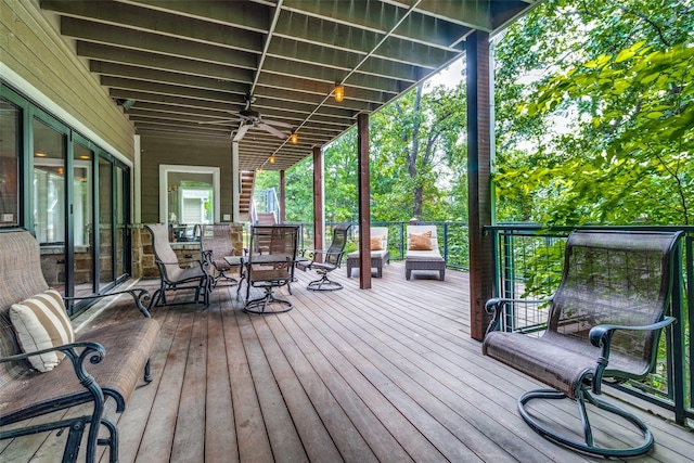 wooden deck featuring ceiling fan