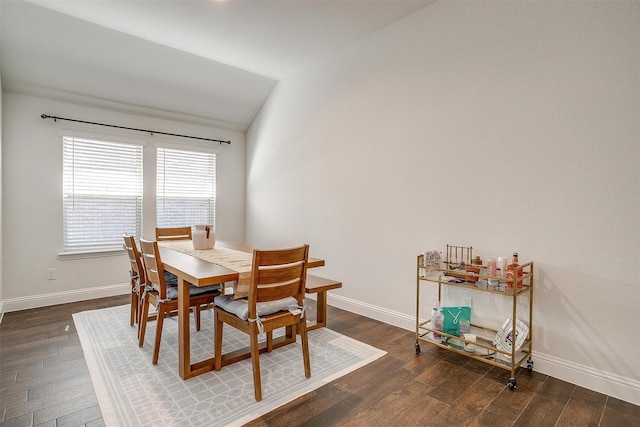 dining area with lofted ceiling and dark hardwood / wood-style floors