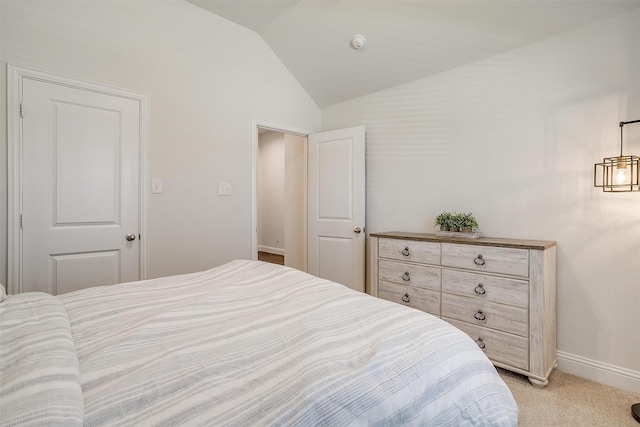 bedroom with vaulted ceiling and light colored carpet