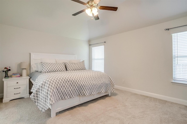 carpeted bedroom with vaulted ceiling and ceiling fan