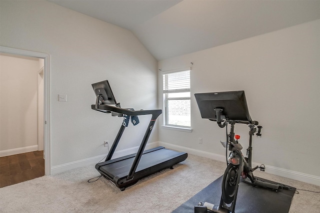 workout room featuring carpet floors and vaulted ceiling