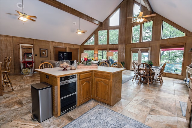 kitchen featuring high vaulted ceiling, ceiling fan, and beam ceiling