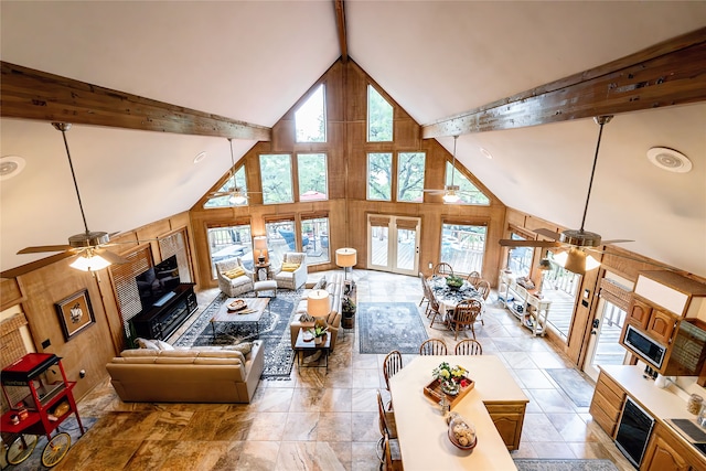 tiled living room with high vaulted ceiling, ceiling fan, beamed ceiling, and a wealth of natural light