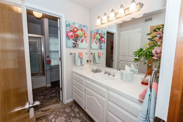 bathroom featuring vanity with extensive cabinet space