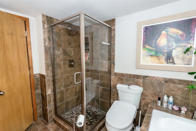 bathroom featuring tile floors, an enclosed shower, tile walls, sink, and toilet