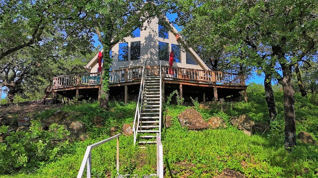 rear view of property featuring a wooden deck