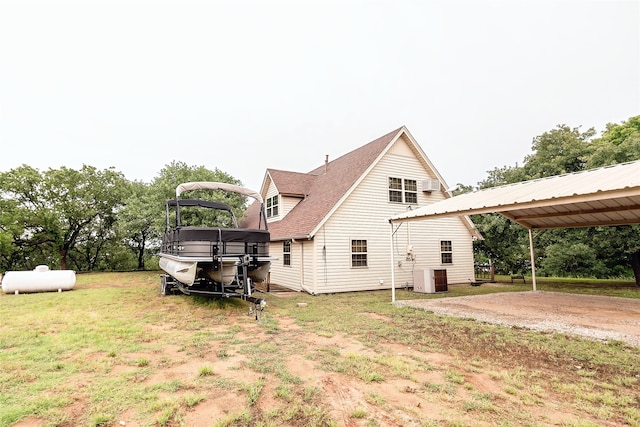 back of house featuring central AC and a yard