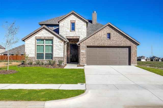 view of front of house with a garage and a front yard