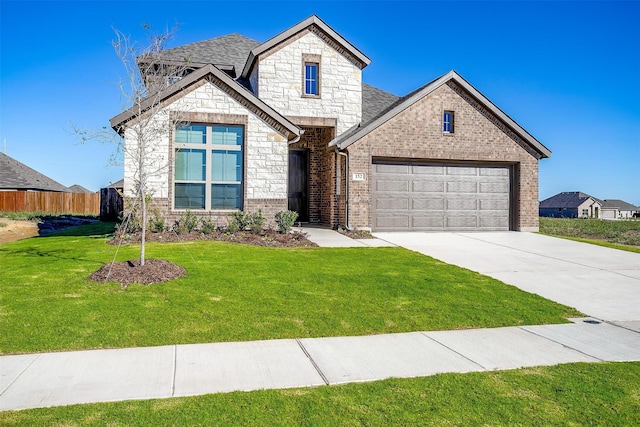 view of front of house with a garage and a front lawn