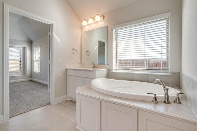 bathroom featuring tile patterned floors, lofted ceiling, and a wealth of natural light